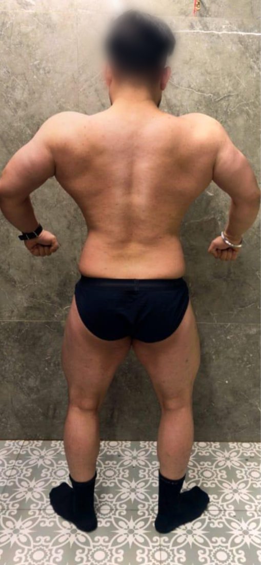 After photo from a client fitness transformation, face softly blurred for privacy